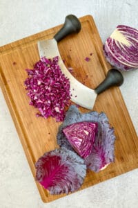 Using a mezzaluna to chop red cabbage.