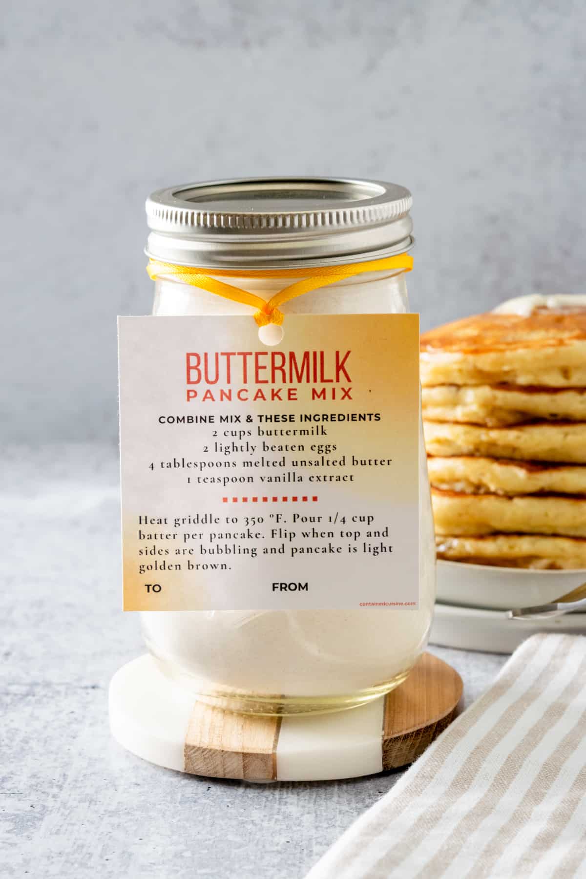 Homemade buttermilk pancake mix in a mason jar with gift tag.
