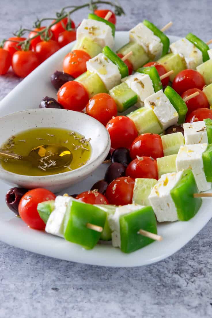 Greek salad skewers drizzled in olive oil and dried oregano flakes.