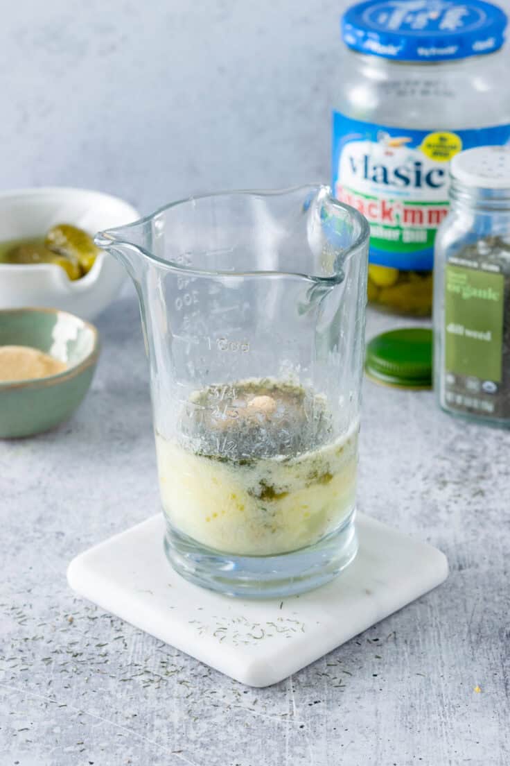 Dill pickle juice, dried dill, ranch dressing and garlic powder added to melted butter.