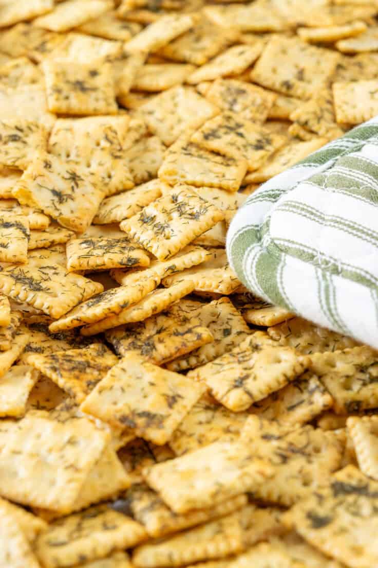 Baked crispy dill pickle saltines being removed from oven.