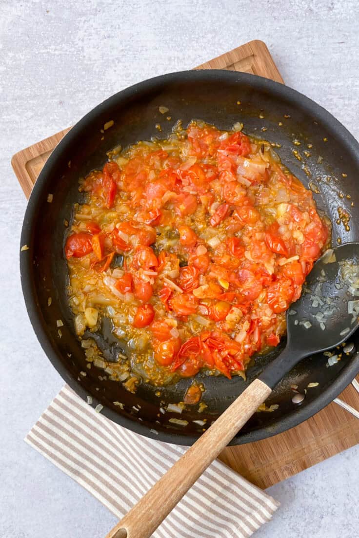 Cherry tomatoes burst and mashed into a sauce.