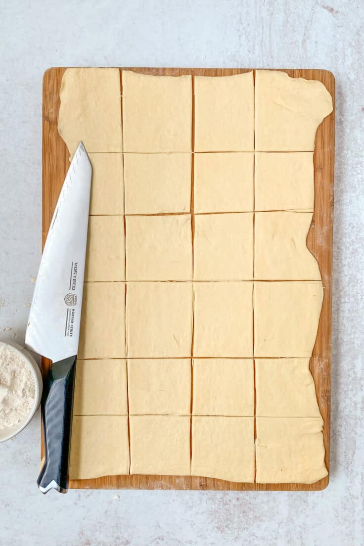 The crescent dough sheet rolled out to make it larger, and cut into 24 square pieces.