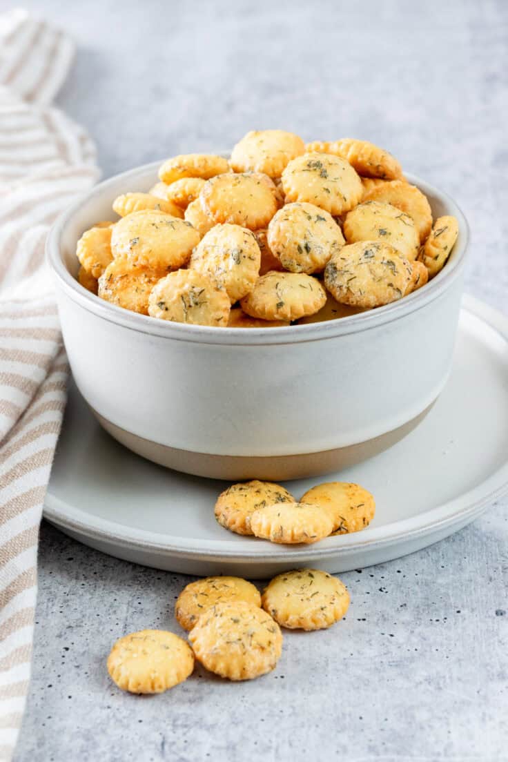 Bowl of ranch oyster crackers showing dill and ranch seasoning coated on crackers.