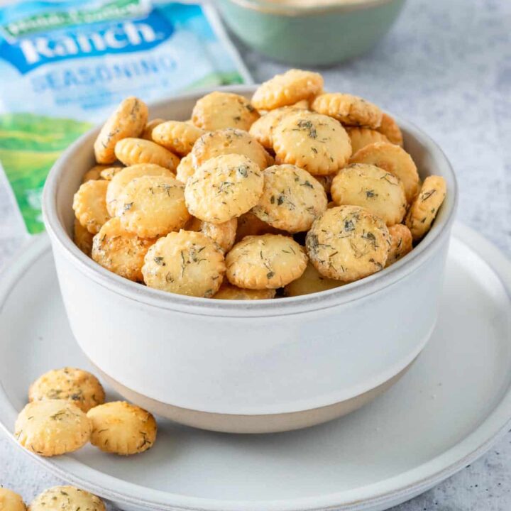 Bowl of ranch oyster crackers next to an envelope of ranch seasoning mix.