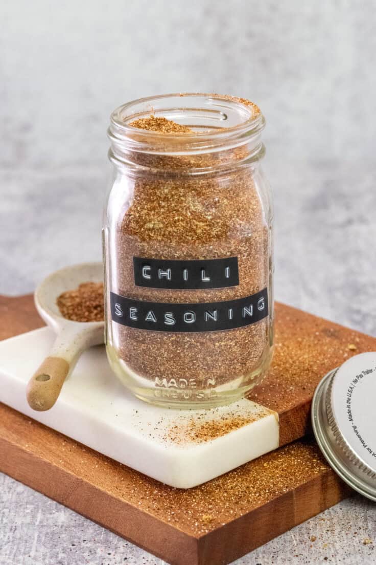 Homemade chili seasoning mix in a glass jar with a black label on it that says, chili seasoning.