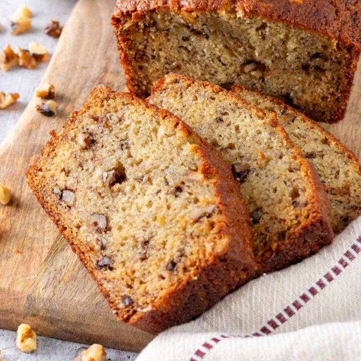 A loaf of homemade banana bread and banana bread slices showing how moist it is.