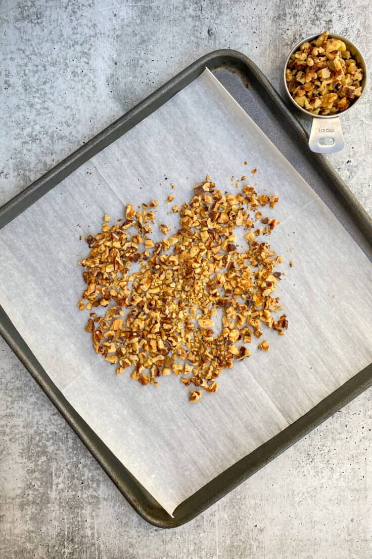 Toasted walnuts on a baking tray.