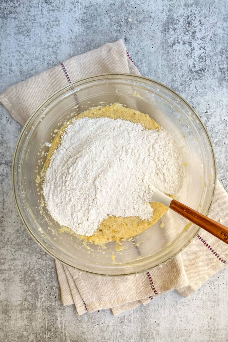 Dry ingredients poured on top of wet ingredients in a bowl.