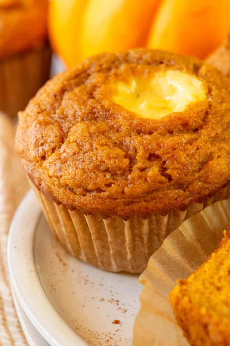 A close up photo showing how moist this pumpkin cream cheese muffin is.