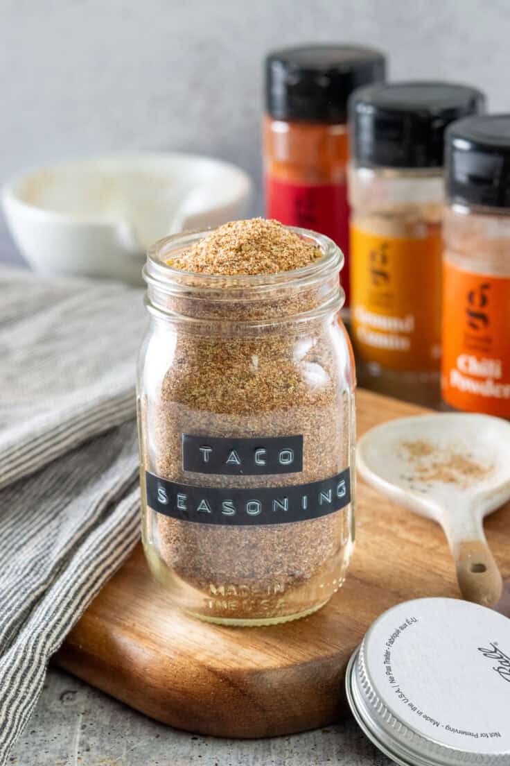 A spice jar full of homemade taco seasoning.