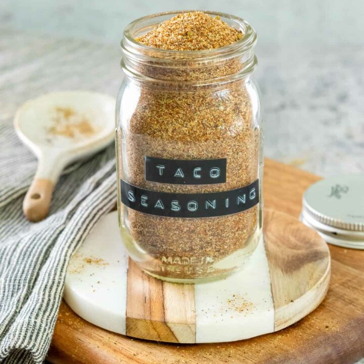 Jar of homemade taco seasoning with a label on the spice jar that says, taco seasoning.