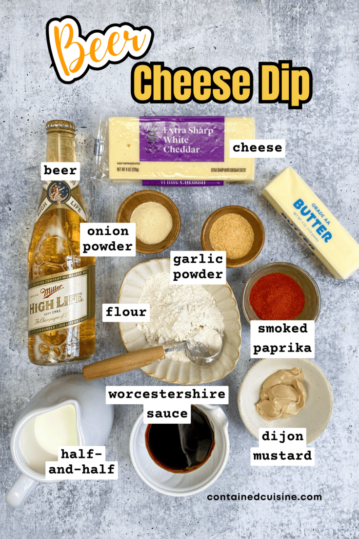 Overhead picture showing all the ingredients needed to make homemade beer cheese dipping sauce, including a bottle of beer and block of cheddar cheese.