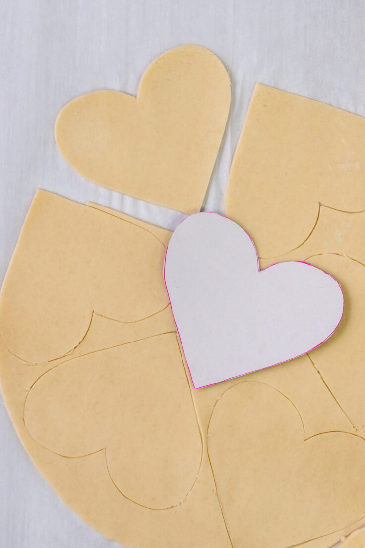 Pie crust with hearts cut out of it.