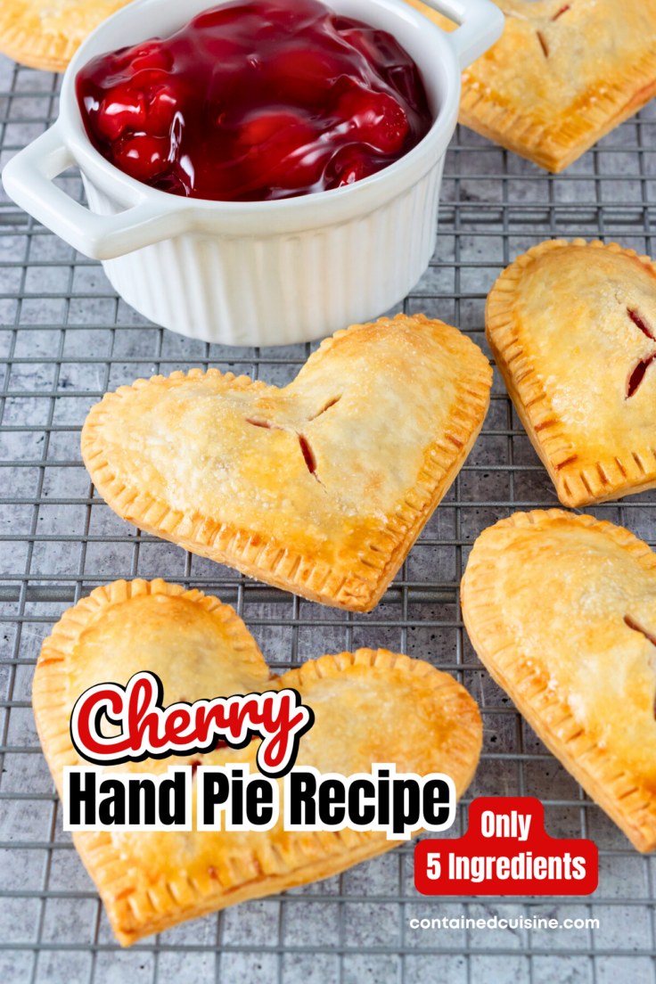 Heart-shaped cherry hand pies on a cooling rack next to a bowl of cherry pie filling. The image has the text overlay, Cherry Hand Pie Recipe, Only 5 Ingredients.