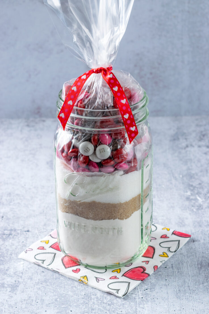 Valentine cookie mix in a jar with the bag of M&M's and chocolate chips added on top.