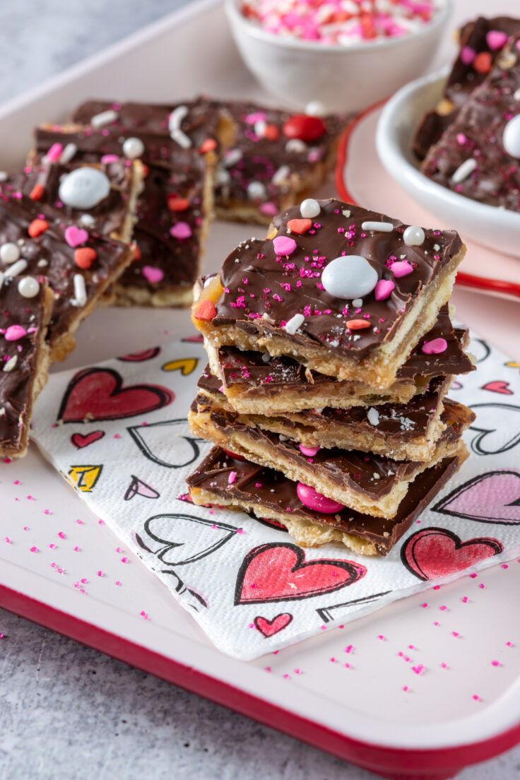 Valentine Crack Candy spread out on a pink and red tray for parties.