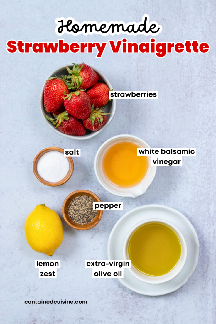 Overhead picture showing each ingredient needed to make homemade strawberry vinaigrette, including bowls with strawberries, white balsamic vinegar, extra-virgin olive oil, salt, and pepper. There is also a whole lemon.