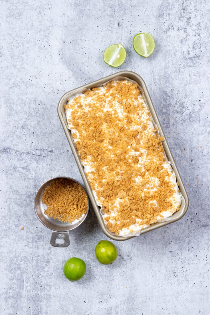 The no-churn, homemade key lime pie ice cream is covered in graham cracker crumbs.
