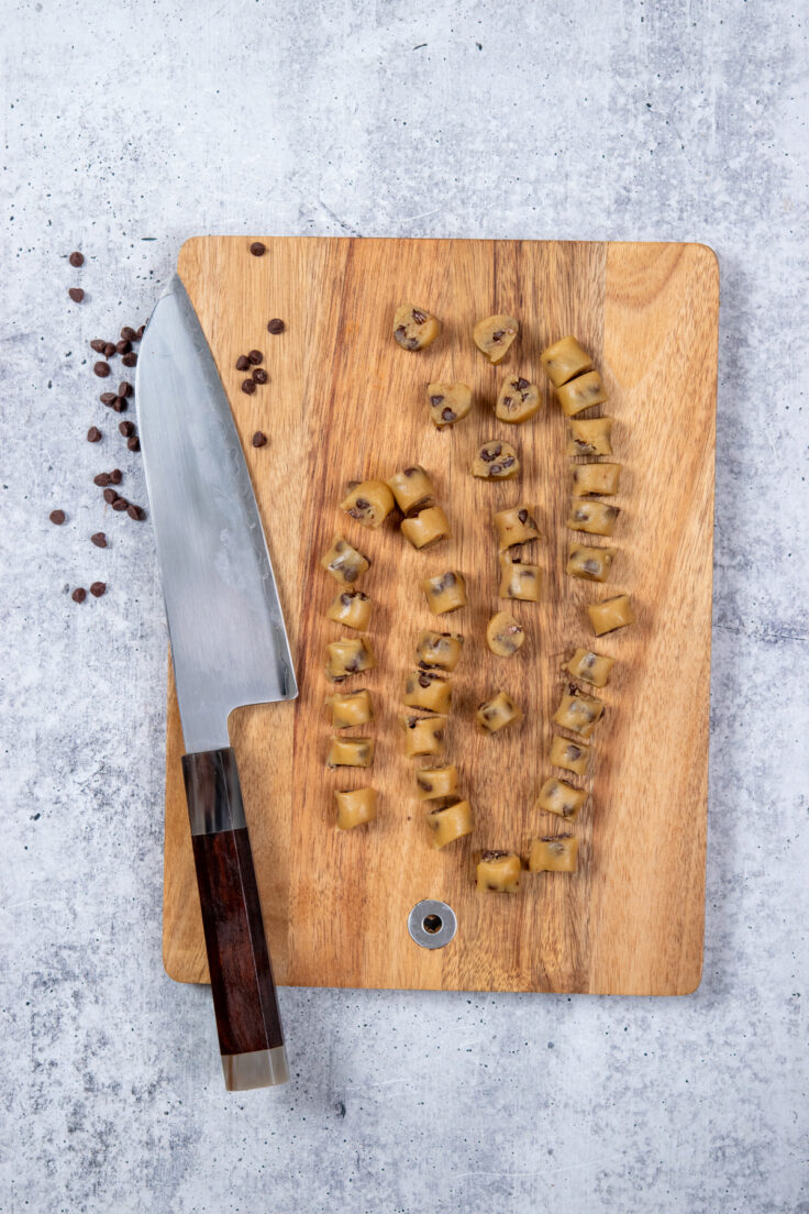 Tiny 1/2 inch pieces of cookie dough sliced from the logs of chilled dough.