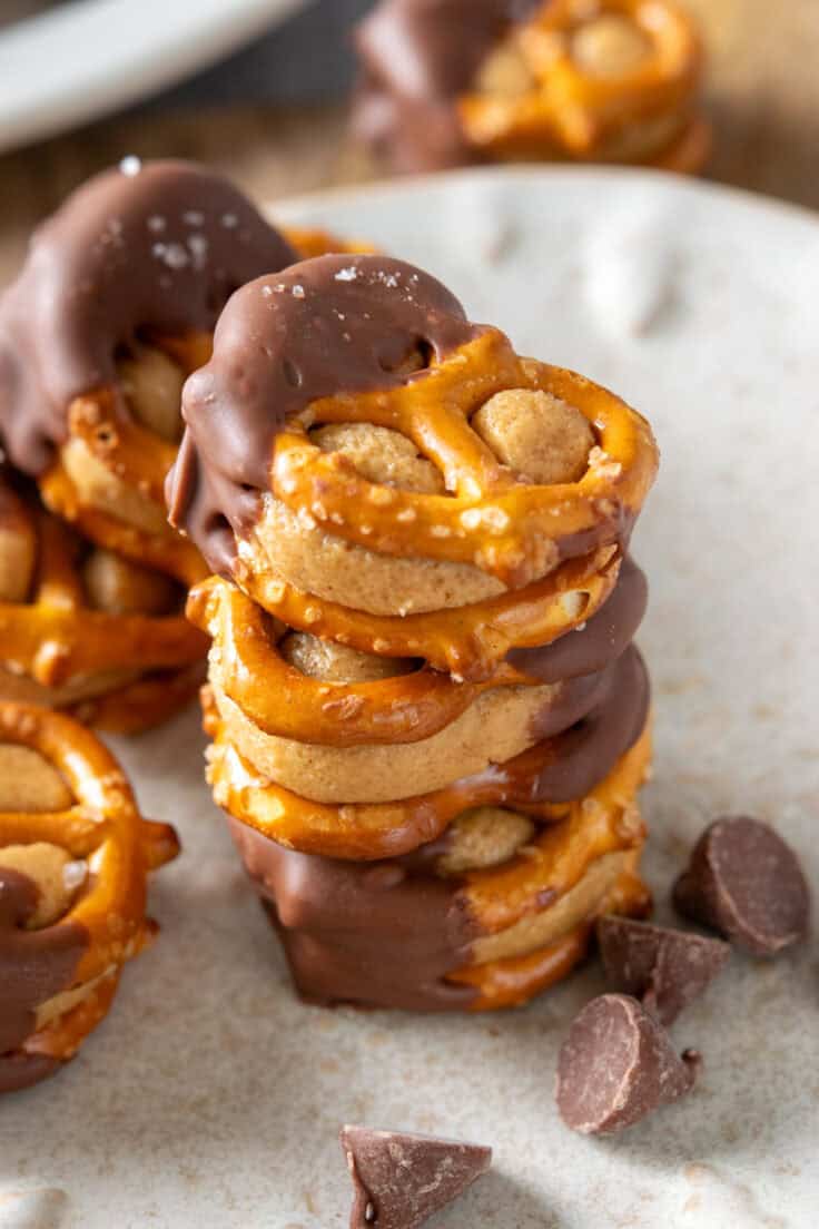 A stack of three peanut butter pretzel bites dipped in chocolate.