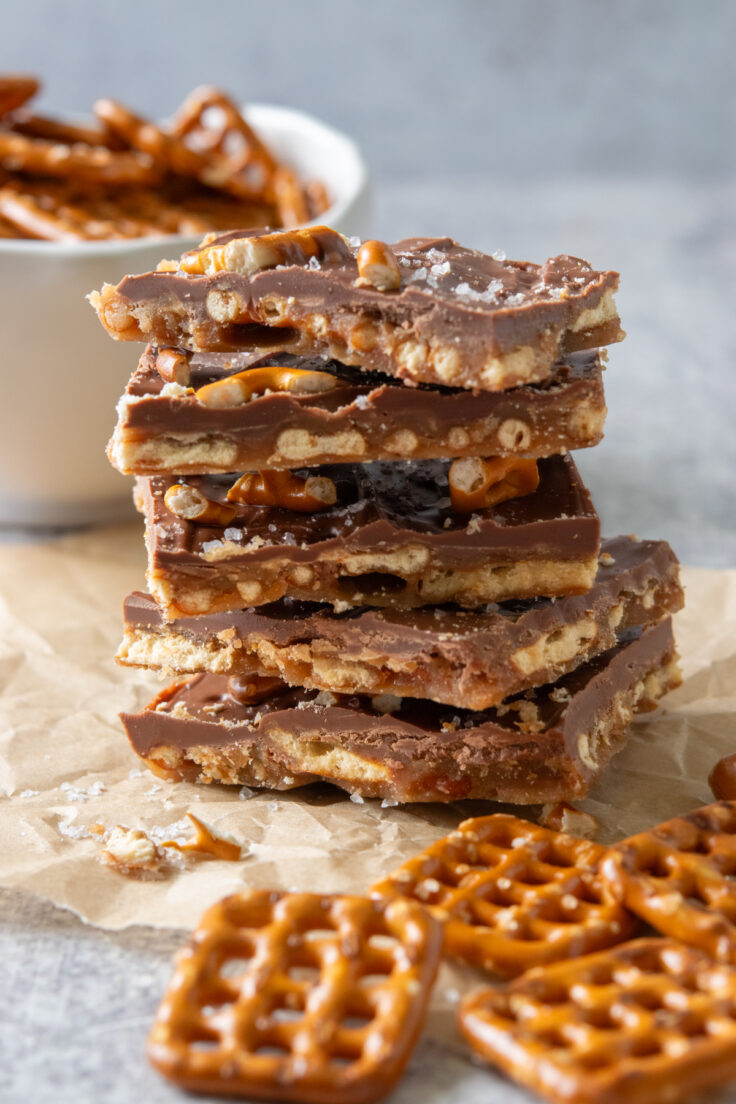 A side view of a stack of pretzel bark showing the pretzel, toffee and chocolate layers.