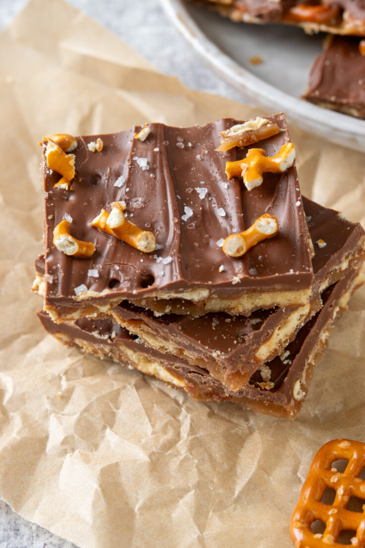 Chocolate-covered caramel pretzel bark with flaky sea salt and bits of pretzels on top.