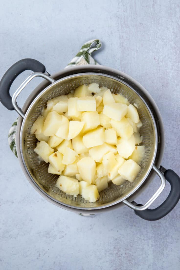 Boiled potatoes in a strainer.