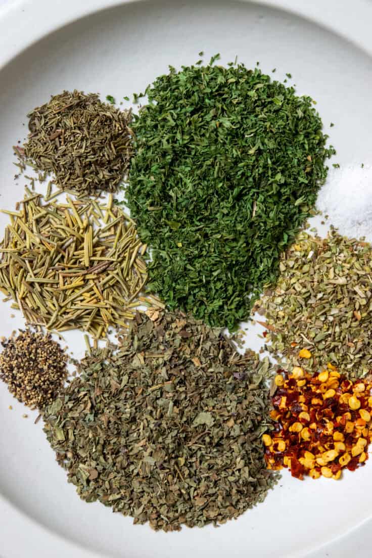 An overhead view showing piles of each spice that goes into the seasoning, on a plate.