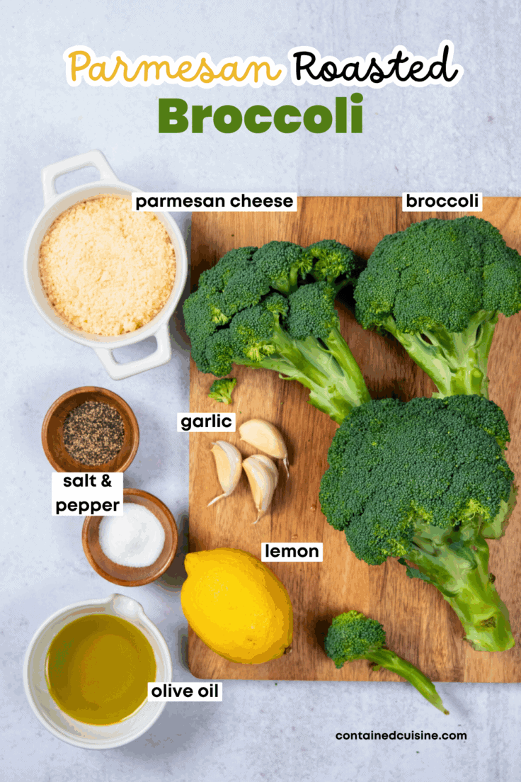 Parmesan Roasted Broccoli recipe ingredients, including a small bowl with grated parmesan cheese, fresh broccoli, a lemon, some garlic cloves and salt and pepper.