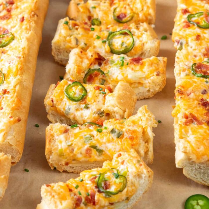 Three loaves of jalapeño popper cheese bread, one sliced for serving as an easy party snack or appetizer.