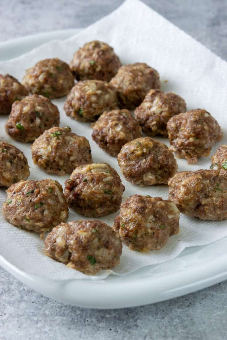 Baked meatballs on a paper towel-lined dish to absorb any unwanted grease or fat.