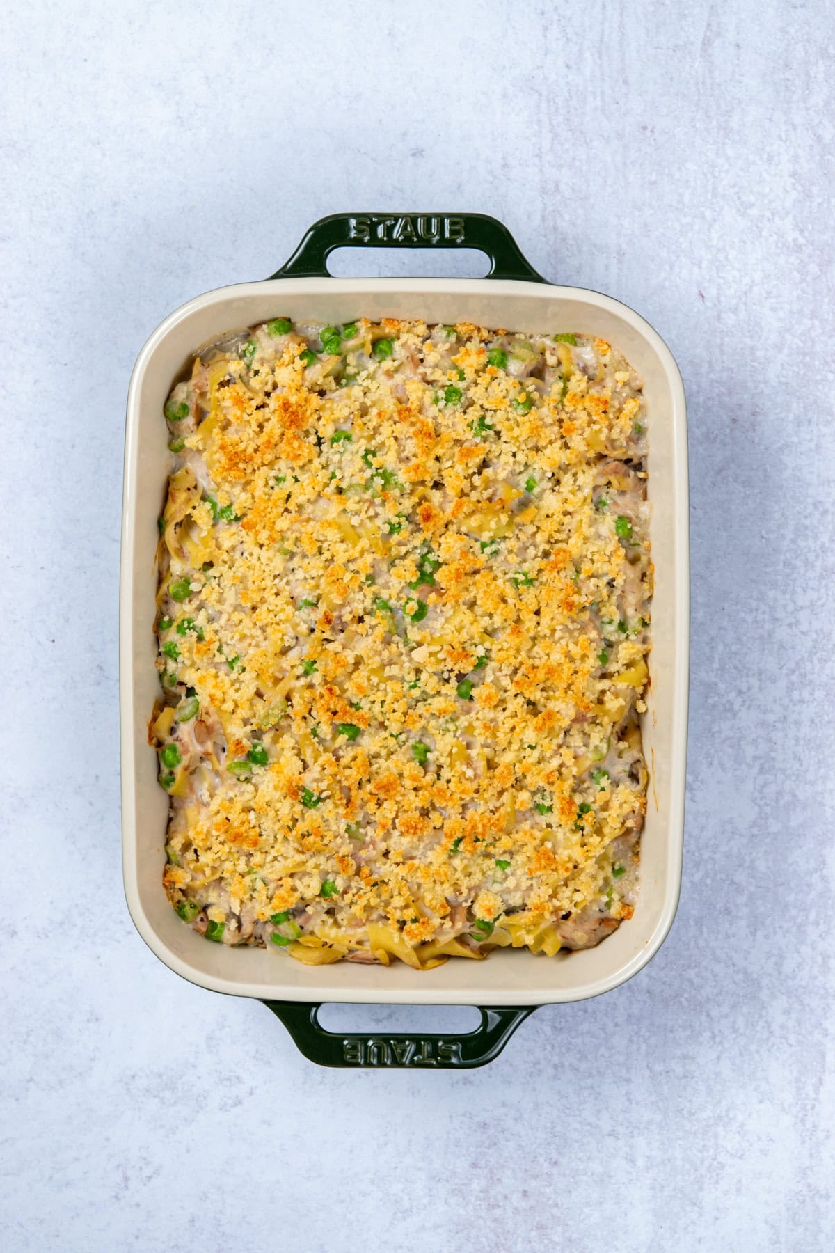 Baked tuna noodle casserole with creamy cream of mushroom sauce and a buttery, crispy parmesan-bread crumb topping, hot out of the oven,
