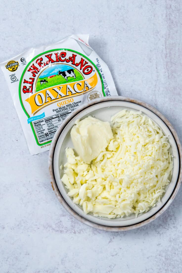 Shredding queso Oaxaca cheese by hand for cheesy baked tacos.