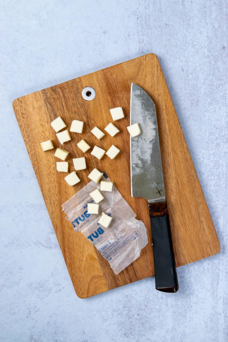 Cold cubes of unsalted butter prepared for homemade Cheez-Its dough.