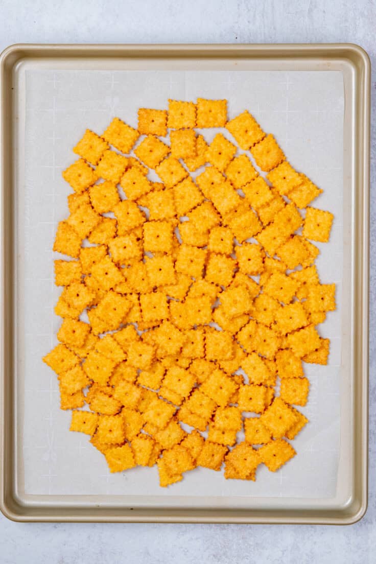 A pile of homemade Cheez-Its on a baking sheet.