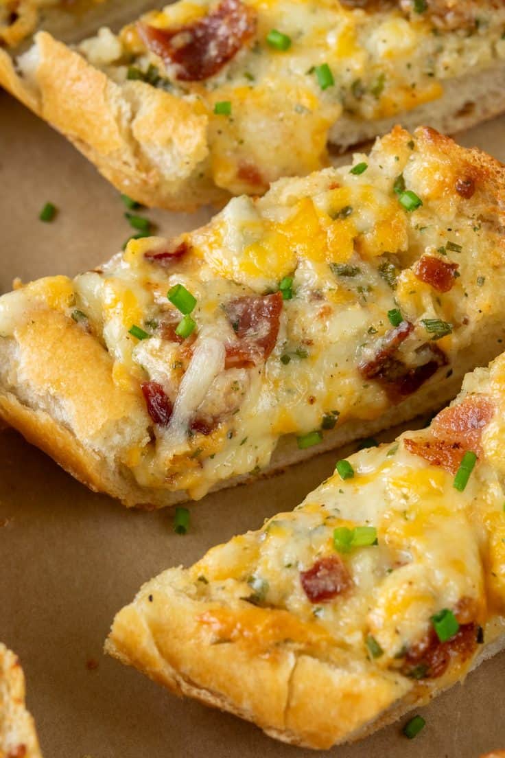 Close-up of a small serving piece of bacon ranch cheese bread topped with crispy bacon and melted cheese, with soft bread underneath and golden edges.